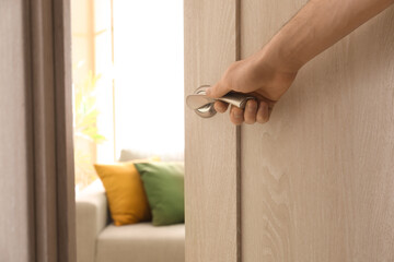 Wall Mural - Man opening light wooden door, closeup