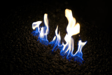 Canvas Print - Closeup of burning fire flames on small rocks