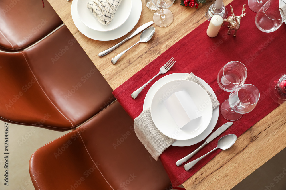 Festive table setting for Christmas celebration in dining room