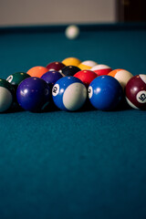 Poster - Vertical shot of colored billiard balls on a pool table