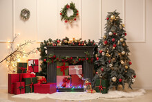 Beautifully Decorated Fireplace With Christmas Tree And Gifts In Living Room