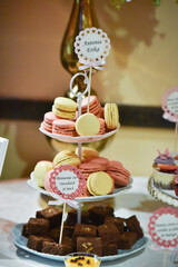 Poster - Vertical shot of a bunch of colorful macaroons on a wedding buffet