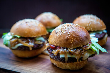 Sticker - Delicious cheeseburgers with crispy bun on a wooden boa