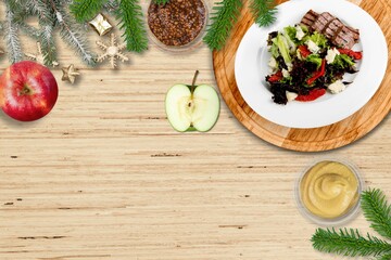 Sticker - Christmas meat dish. Festive decorated wooden table for Christmas Dinner