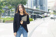 © eakgrungenerd - successful asian businesswoman wear black suit holding tablet walking city street. woman freelancer lifestyle human urban. copy space use for text word.