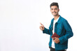 © Niks Ads - Young Indian man standing and holding dairy in hand on white background.