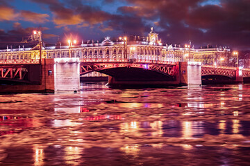 Wall Mural - Saint Petersburg christmas. Russia night. Palace bridge in Saint Petersburg. Neva river with snow. Winter Palace. Petersburg Christmas evening. New Year lights reflected in water. Russian Federation