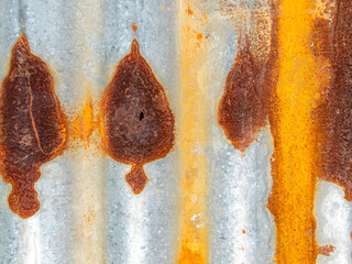 Rusty marks that look like leaf on the zinc plate wall with beautiful abstract and art pattern with orange color of rust