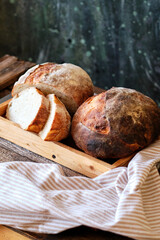 Wall Mural - Homemade sourdough bread. Wooden background, side view.