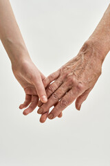 Wall Mural - Senior grandmother and young girl holding hands