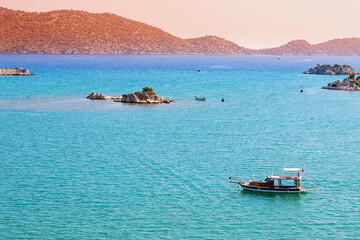 Poster - Kekova Island with its famous sunken city is one of the most popular resorts in Turkey attracts many travelers on boat tours and sea cruise ships. Idyllic aerial view at sunset