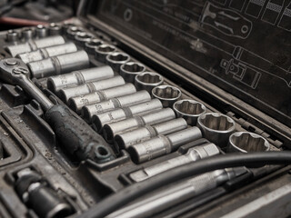 A set of tools and wrenches in a car workshop