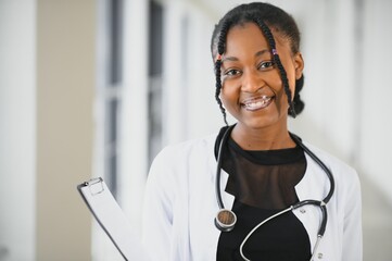 Wall Mural - beautiful african american female pediatric nurse in modern office