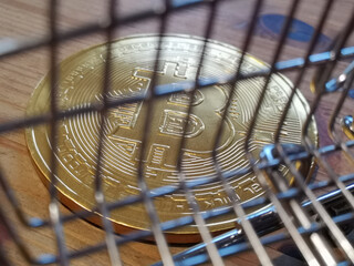 Wall Mural - Closeup of the bitcoin behind the shopping cart.