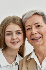 Wall Mural - Smiling granddaughter and grandmother head to head