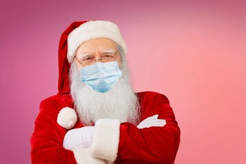 Wall Mural - Real Santa Claus with red background, wearing face mask and glasses. Christmas with social distance. Covid-19