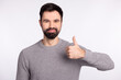 © Tetiana - Photo of young guy show thumb-up promotion choose recommend advert isolated over grey color background
