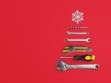 Fototapeta Sypialnia - Christmas tree made of construction tools with a snowflake on a background. New Year's concept for a car workshop.