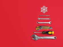 Christmas Tree Made Of Construction Tools With A Snowflake On A Background. New Year's Concept For A Car Workshop.