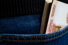 A Wad Of Money Sticks Out Of The Pocket Of Jeans, Russian Five-thousand-dollar Bills.
