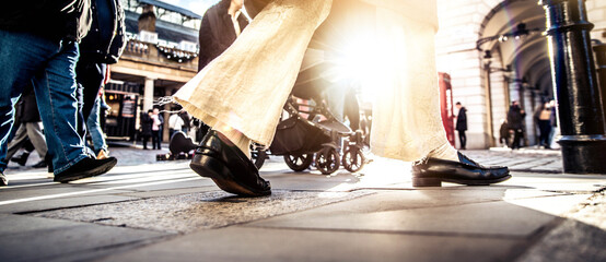 Anonymous crowd of people walking on busy city street - City life concept