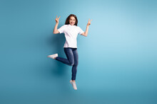 Full Body Photo Of Young Cheerful Girl Jumper Show Fingers Peace Cool V-symbol Isolated Over Blue Color Background
