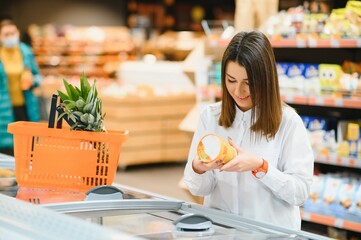 Wall Mural - Woman grocery shopping and looking very happy