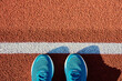 Blue running sneakers at stadium track