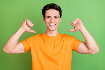 Poster - Photo of happy young charming man good mood smile point fingers himself isolated on green color background