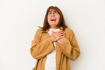 Wall Mural - Middle age caucasian woman isolated on white background laughing keeping hands on heart, concept of happiness.