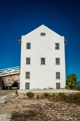 Vertical shot of a white building, the exterior design and windows with clear sky