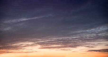 Wall Mural - sky panorama at sunset, grey clouds above and orange afterglow below