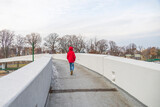Fototapeta Big Ben - boy walking on a cement pathway on a bridge