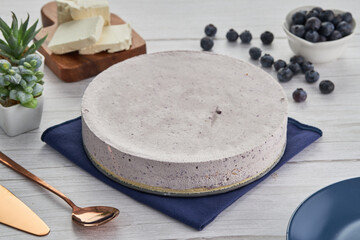 Canvas Print - Closeup shot of a blueberry cream cake, berries, and other ingredients