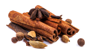 Cinnamon sticks and spieces close up on wooden table. Dark style