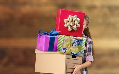 Wall Mural - Young beautiful woman hold paper gift boxes stack. Festive Christmas and New Year holidays