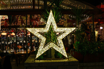 Wall Mural - Closeup of a bright star in a Christmas decorated interior