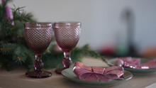 Two Pink Glasses On A Serving Table. Two Pink Bows On The Plates.