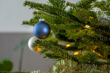 Christmas Tree With Balls. Shiny Christmas Blue Ball Hanging On Pine Branches