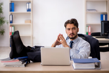 Young male employee working in the office