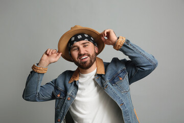 Poster - Fashionable young man in stylish outfit with bandana on grey background