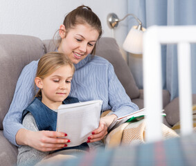 Mother and the teenage daughter do school tasks together at home. High quality photo