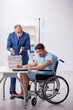 © Elnur - Young male employee in wheel-chair feeling bad at workplace