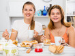 © JackF - Smiling young friends drinking tea with pie at the table at home