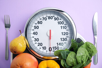 Poster - Scales, healthy food and cutlery on violet background, flat lay