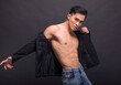 © Tom Wang - Strong, fit and handsome asian young  man over black background