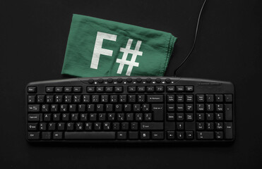 f sharp programming language. rag width word f# and hands on pc keyboard.