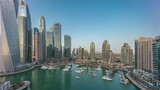 Fototapeta  - Dubai marina tallest skyscrapers and yachts in harbor aerial day to night timelapse.