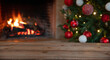 © Rawf8 - Christmas tree and burning fireplace background. Wooden table desk empty, template