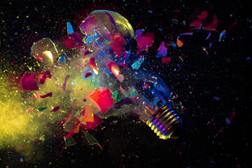 Wall Mural - explosion of a colorful light bulb on black.